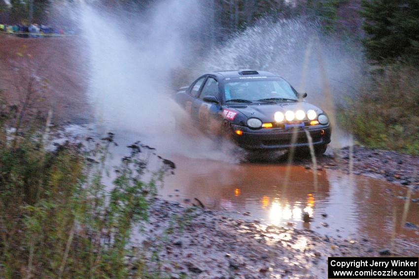 Bryan Holder / Tracy Payeur Plymouth Neon hits the final big puddle at the end of Gratiot Lake 2, SS14, at speed.