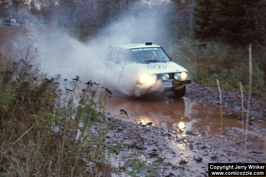 Brett Fairbanks / Chris Greenhouse VW Rabbit hits the final big puddle at the end of Gratiot Lake 2, SS14, at speed.