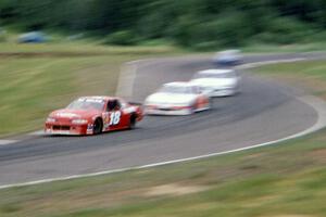 Lou Gigliotti's Chevy Lumina leads a group of cars through 7/8