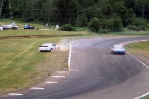 Scott Hansen's Chevy Lumina spins at turn 7 as Bob Senneker's Ford Thunderbird goes by.