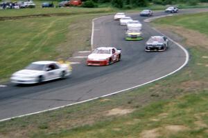 The pace car leads Johnny Benson, Jr.'s Chevy Lumina and the rest of the field through turns 7/8