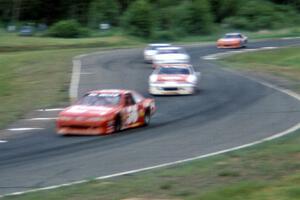 Brett Bell's Ford Thunderbird leads a pack through turns 7/8