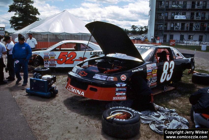 Greg Freed's Chevy Lumina and Butch Miller's Ford Thunderbird in the paddock