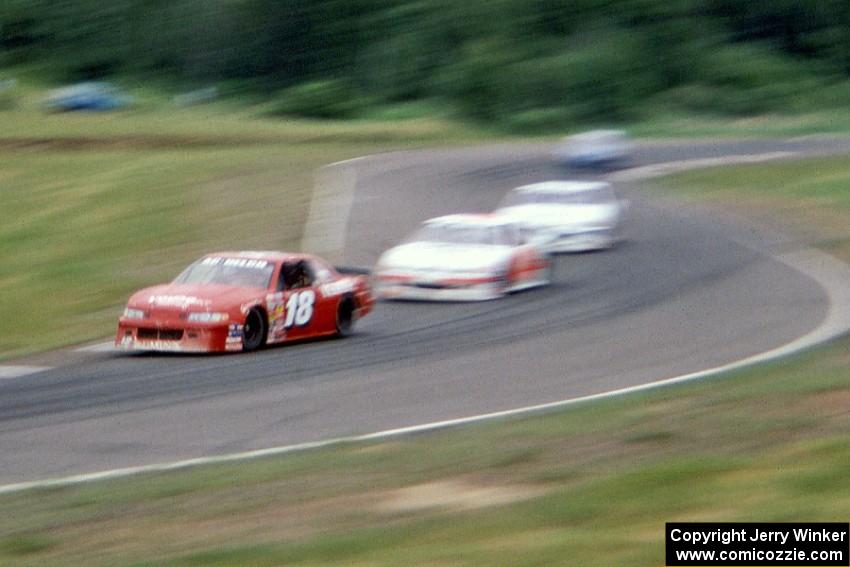 Lou Gigliotti's Chevy Lumina leads a group of cars through 7/8