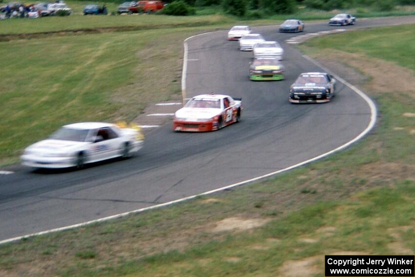 The pace car leads Johnny Benson, Jr.'s Chevy Lumina and the rest of the field through turns 7/8