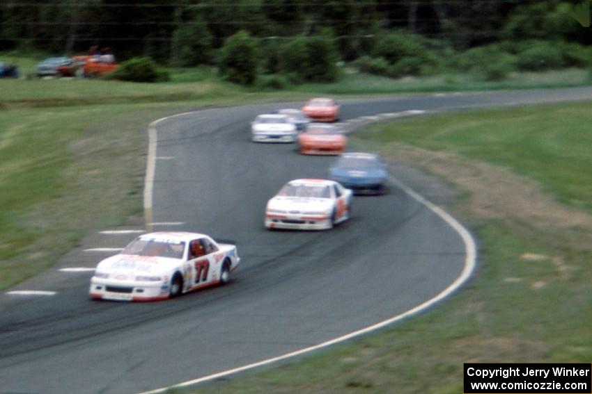 Dave Watson's Chevy Lumina and Butch Miller's Ford Thunderbird lead a group of cars through turns 7/8