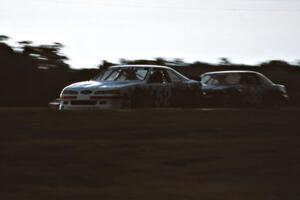 Butch Miller's Ford Thunderbird and Mike Eddy's Pontiac Grand Prix before the rain hit during the qualifier