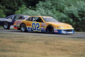 Bobby Archer's Chevy Lumina passes Randy Ruhlman's Ford Thunderbird into turn 3.