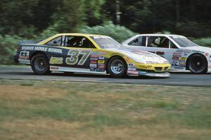 David Anspaugh's Pontiac Grand Prix tries to pass Darren Law's Chevy Lumina into turn 3.