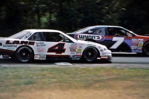 Gary St. Amant's Ford Thunderbird keeps ahead of Dave Sensiba's Chevy Lumina out of turn 3.