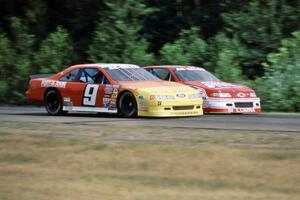 Dennis Lampman's Ford Thunderbird gets the inside line on Steve Shive's Chevy Lumina at turn 3.