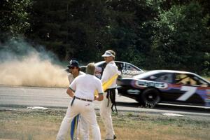 Mike Eddy's Pontiac Grand Prix spins at turn 3 as Gary St. Amant's Ford Thunderbird passes by.