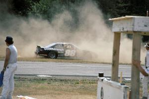 Mike Eddy's Pontiac Grand Prix gets refired at the outside of turn 3