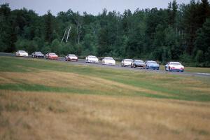 Ken Schrader's Chevy Monte Carlo leads the field into turn 3