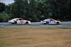 Ken Schrader's Chevy Monte Carlo leads John Cadman's Ford Thunderbird