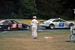 Scott Hansen's Ford Thunderbird leads Jay Sauter's Pontiac Grand Prix