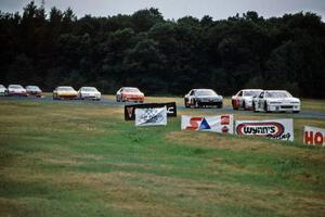 Brandon Sperling's Chevy Lumina leads John Freeman's Chevy Monte Carlo and Jay Sauter's Pontiac Grand Prix out of turn 3