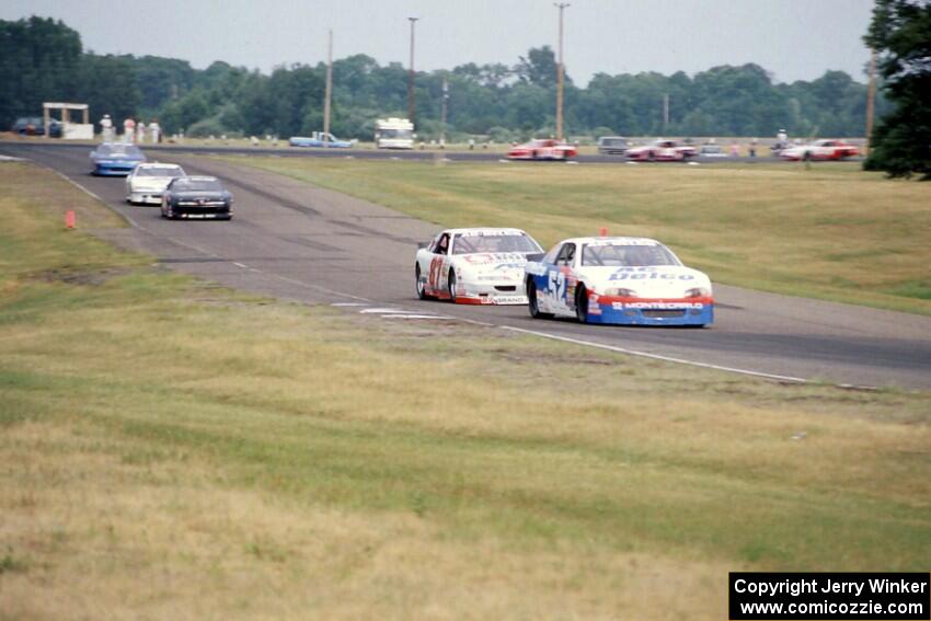 Ken Schrader's Chevy Monte Carlo and Tony Raines' Pontiac Grand Prix lead the field into 7/8.