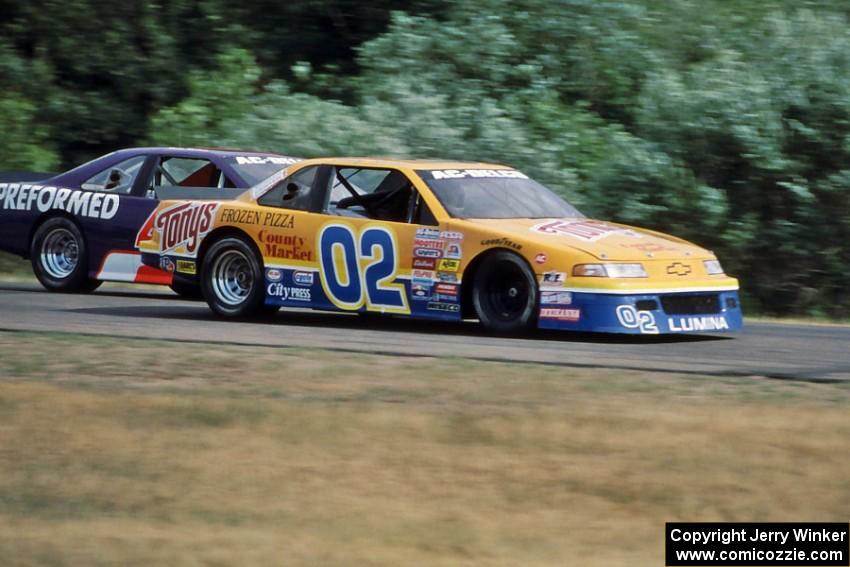 Bobby Archer's Chevy Lumina passes Randy Ruhlman's Ford Thunderbird into turn 3.