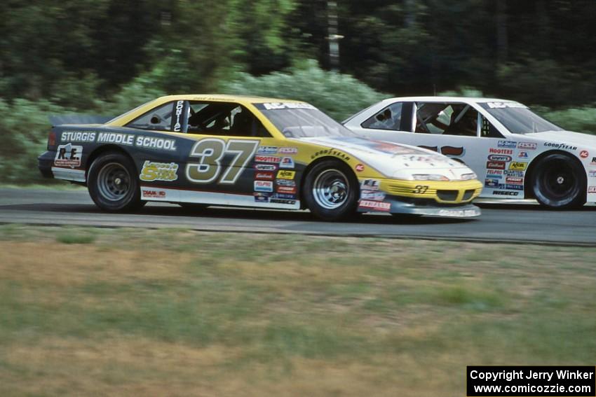 David Anspaugh's Pontiac Grand Prix tries to pass Darren Law's Chevy Lumina into turn 3.