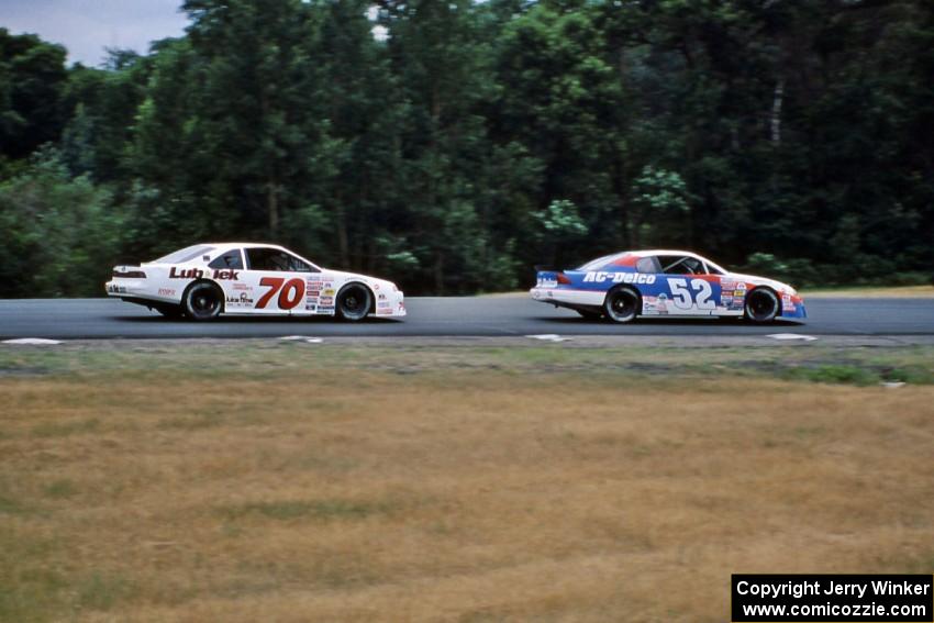 Ken Schrader's Chevy Monte Carlo leads John Cadman's Ford Thunderbird