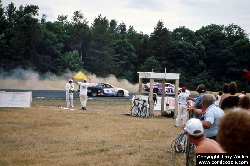 Rick Miller's Chevy Monte Carlo goes wide at 3 as Tom Jones' Pontiac Grand Prix catches him