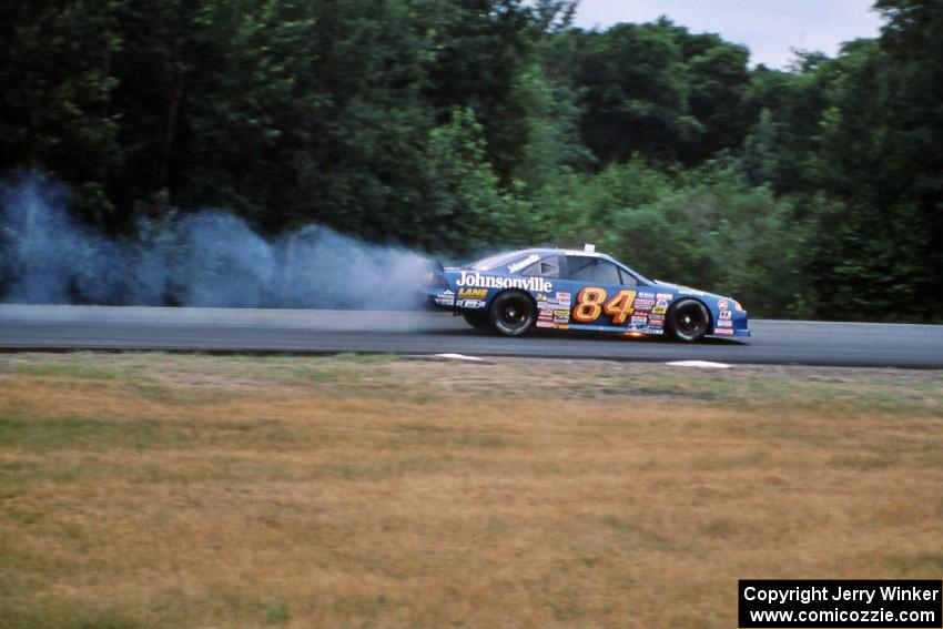 Bob Senneker pops an oil line and catches the engine of his Ford Thunderbird on fire