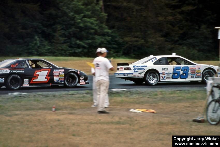 Scott Hansen's Ford Thunderbird leads Jay Sauter's Pontiac Grand Prix