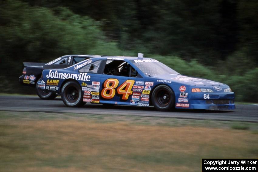 Bob Senneker's Ford Thunderbird passes Jay Sauter's Pontiac Grand Prix into turn 3