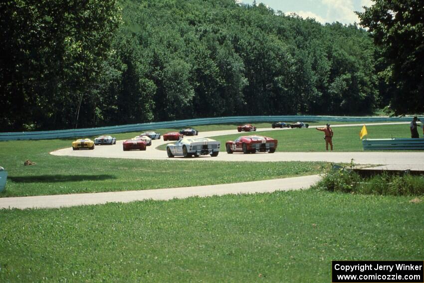 Ford GT-40s through the carousel on the pace lap