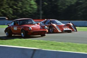 A Porsche 911 is passed by a McLaren M6B GT through Thunder Valley.