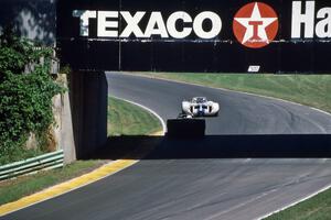 Two early versions of Can-Am cars under the turn 13 bridge.