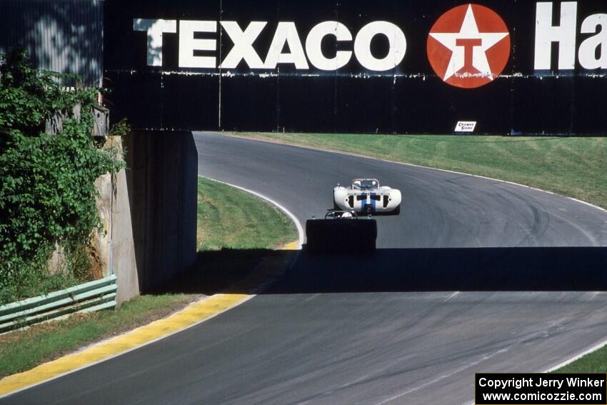 Two early versions of Can-Am cars under the turn 13 bridge.