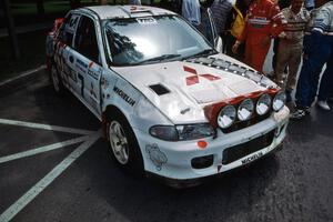 The damaged Henry Joy IV / Michael Fennell Mitsubishi Lancer Evo II at midday service