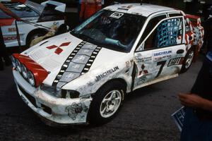 The damaged Henry Joy IV / Michael Fennell Mitsubishi Lancer Evo II at midday service