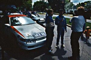 Steve Gingras is interviewed at midday service in front of the Mitsubishi Eclipse he and Bill Westrick shared