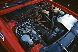 Engine bay of the Jon Kemp / Gail McGuire Audi 4000 Quattro at Germania service