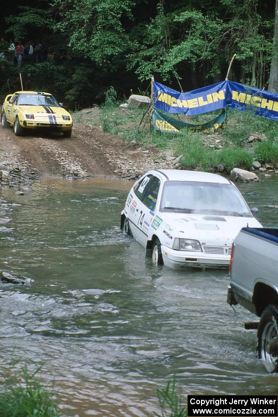 David Liebl / Lou Binkley Mazda RX-7 waits as the Patrick Lilly / Mark McAllister Pontiac LeMans is pulled from the end of SS1.