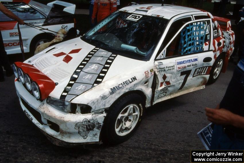 The damaged Henry Joy IV / Michael Fennell Mitsubishi Lancer Evo II at midday service