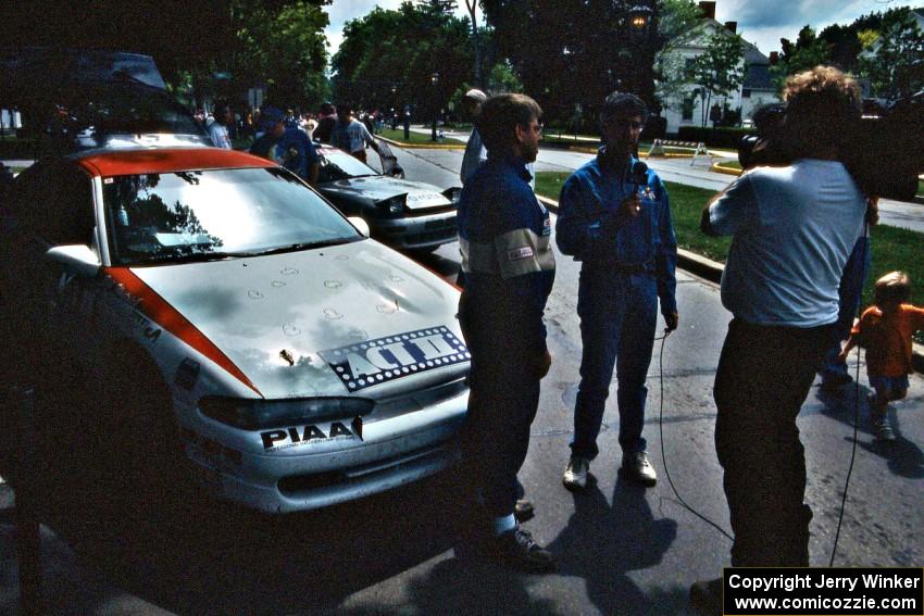 Steve Gingras is interviewed at midday service in front of the Mitsubishi Eclipse he and Bill Westrick shared