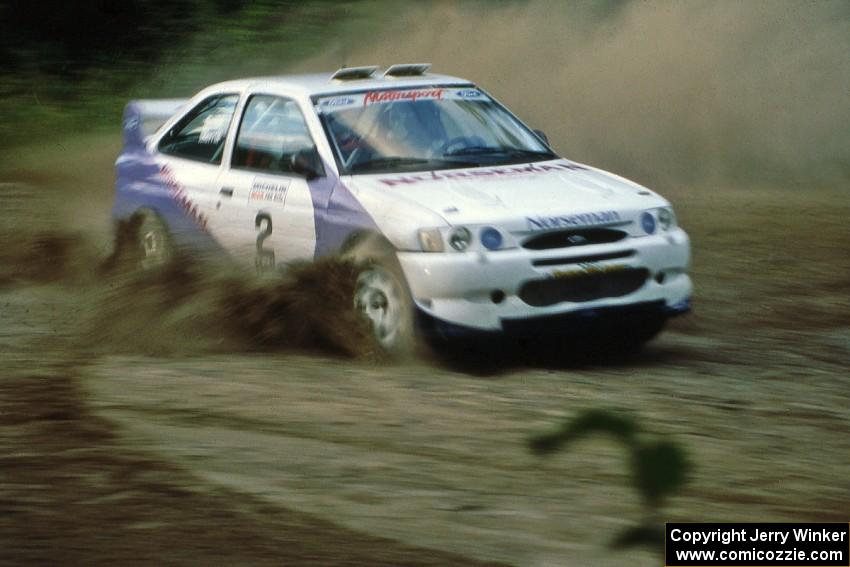 Carl Merrill / Lance Smith Ford Escort Cosworth RS at the spectator point on SS1, Kabekona.
