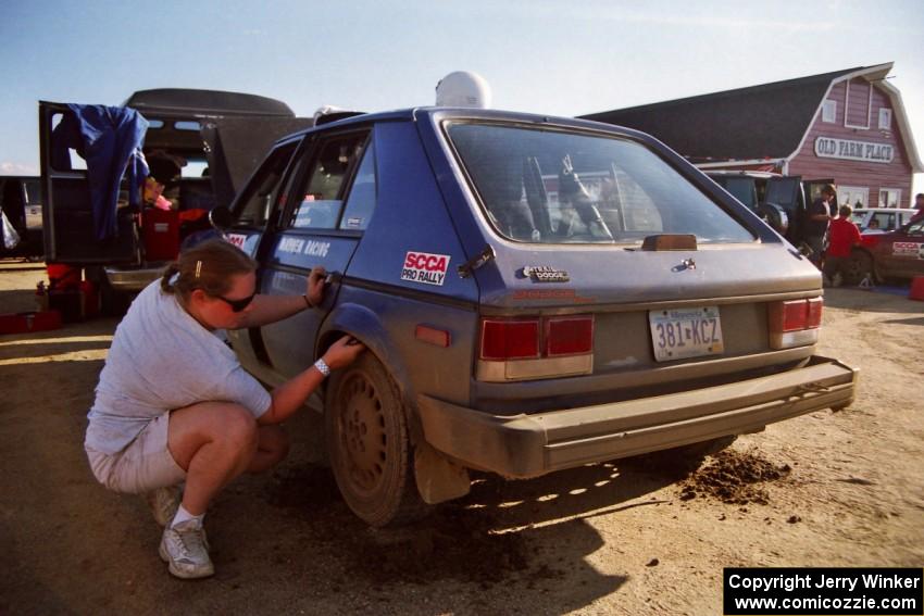 Mary Utecht checks rear-tire clearance on the Mark Utecht / Paul Schwerin Dodge Omni GLH Turbo at Park Rapids service.