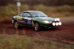 Tad Ohtake / Bob Martin take a hard-right in their Ford Escort ZX2 on the practice stage.