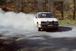 Henry Krolikowski / Cindy Krolikowski drift their Dodge Shadow huge on an early morning stage.