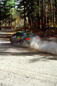 Tad Ohtake / Bob Martin drift their Ford Escort ZX2 through the final corner of SS2.