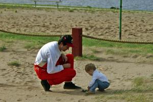 Henry Joy IV takes a break from the rally to play with his son, Henry Joy, while at service.