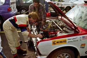 Jimmy Brandt fidgets with the engine on the Datsun 510 he shared with Pete Lahm.