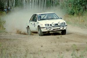 Henry Krolikowski / Cindy Krolikowski blast their Dodge Shadow down a straight near the start of Menge Creek I.