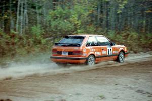 Gail Truess / Nancy Redner drift their Mazda 323GTX through the first corner of Menge Creek I.