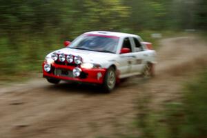 Henry Joy IV / Mike Fennell catch a little air over a culvert near the end of Menge Creek II in their Mitsubishi Lancer Evo II.